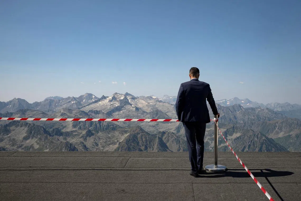 A security guard standing on a rooftop at the Pic du Midi before the arrival of France's President Emmanuel Macron for a presentation by local stakeholders of the application file for the inclusion of the Pic du Midi on the UNESCO World Heritage List, in Bagneres-de-Bigorre, France, on July 17, 2025.  