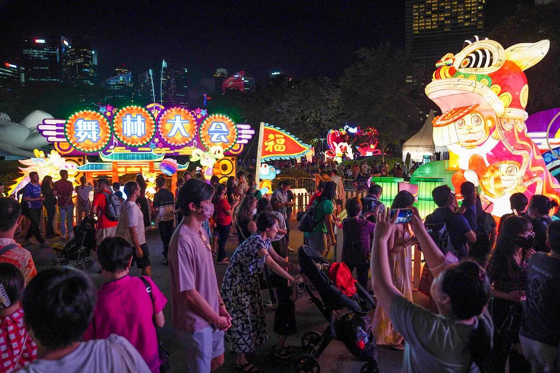 Visitors walking by the Welcome Arch lantern at River Hongbao 2023 located in Gardens By The Bay on Jan 21, 2023.