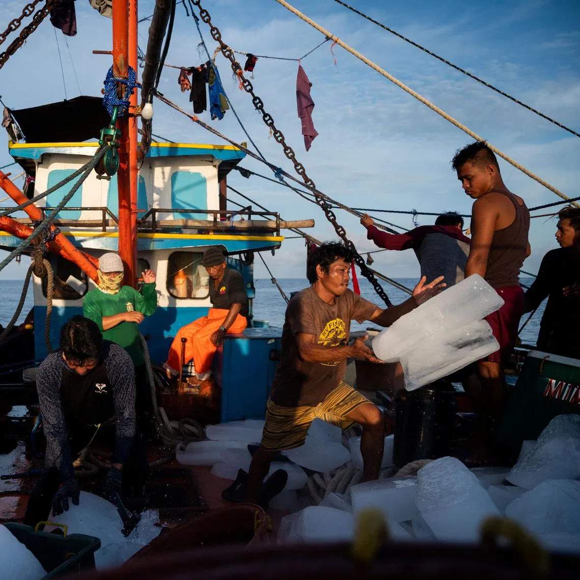Filipino fishemen prepare ice during a trip near the disputed Scarborough Shoal, in Masinloc, Zambales province, Philippines, on July 18, 2022.
