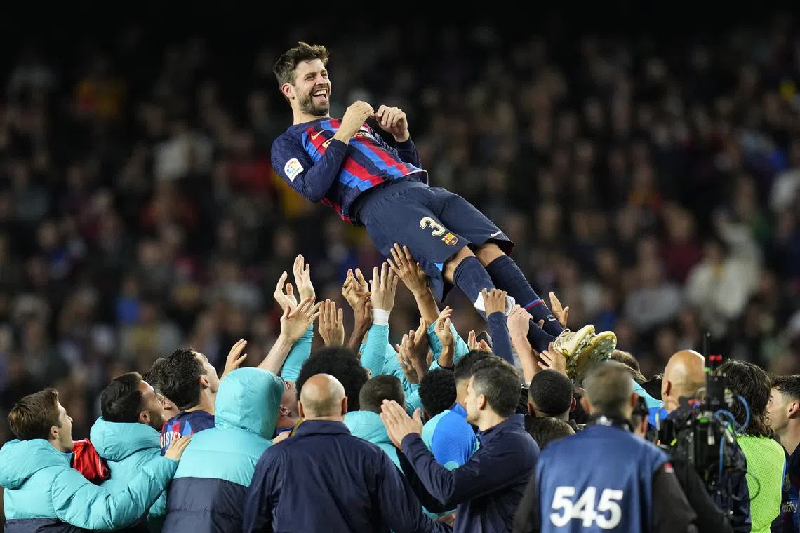 Barcelona defender Gerard Pique is celebrated by his teamates at the end of the match.