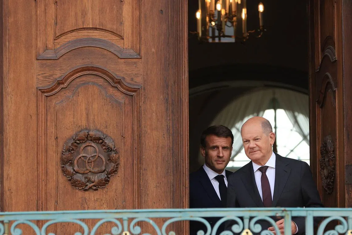 French President Emmanuel Macron (left) and German Chancellor Olaf Scholz are each facing political crises at home.