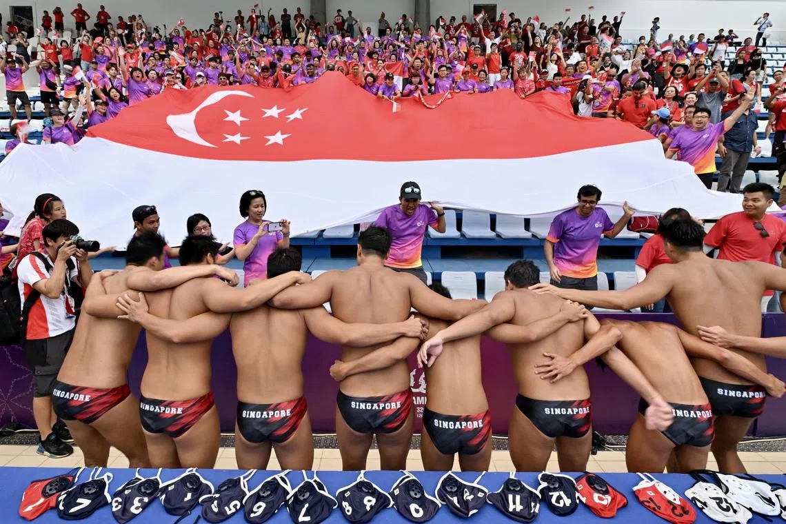 Singapore's water polo team and their supporters celebrating after their 12-5 win over defending champions Indonesia at Phnom Penh’s National Olympic Stadium Swimming Centre on May 14.
