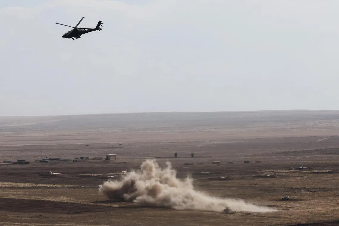 **Embargo till 12 pm on Sep 23, 2023 (SG Time)**

An Apache AH-64D flying past the live-firing area at Saylor Creek Range in Idaho. The helicopter had earlier fired missiles, while another one blasted rounds at the target.
