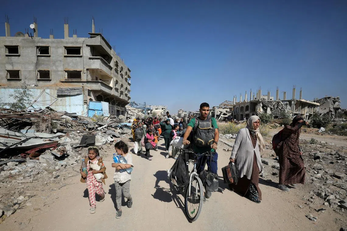 Displaced Palestinians ordered by the Israeli military to evacuate the northern part of Gaza flee amid an Israeli military operation.