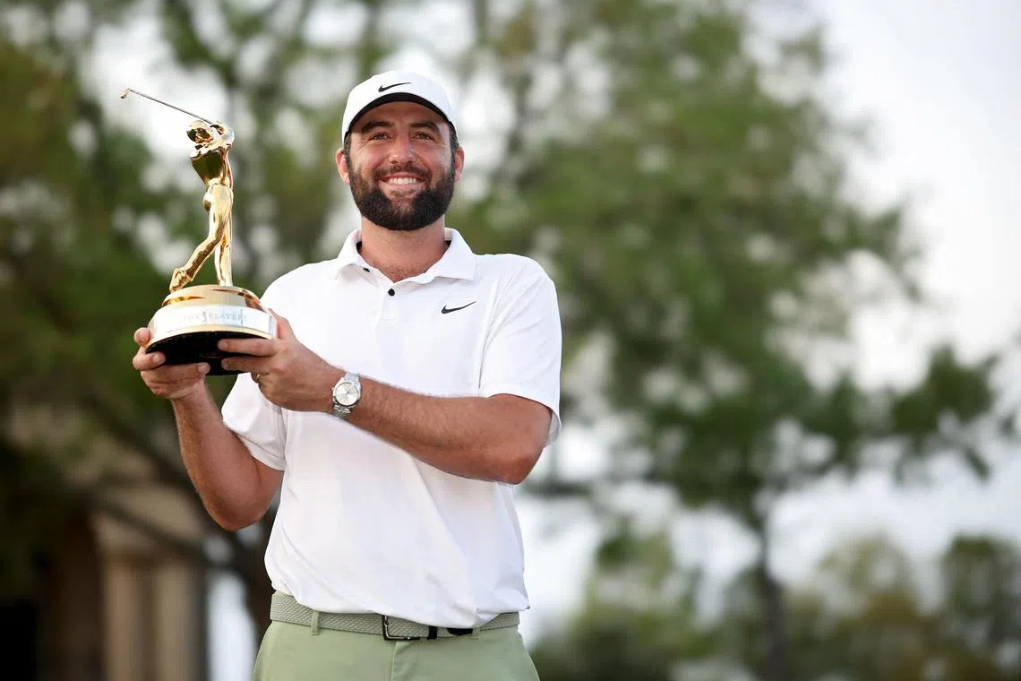 Scottie Scheffler of the United States posing with the trophy after winning The Players Championship at TPC Sawgrass.