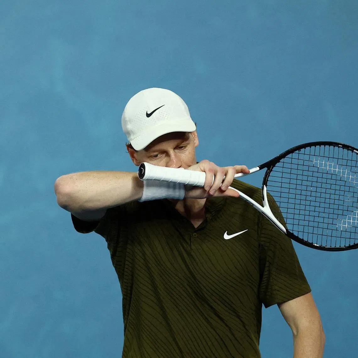 Tennis - Australian Open - Melbourne Park, Melbourne, Australia - January 31, 2026 Italy's Jannik Sinner reacts during his semi final match against Serbia's Novak Djokovic REUTERS/Tingshu Wang