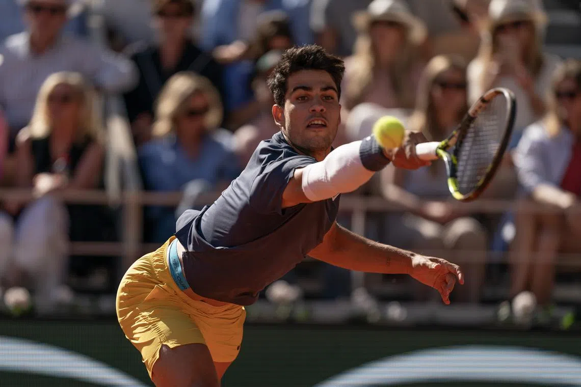 Jun 7, 2024; Paris, France; Carlos Alcaraz of Spain returns a shot during his match against Jannik Sinner of Italy on day 13 of Roland Garros at Stade Roland Garros. Mandatory Credit: Susan Mullane-USA TODAY Sports