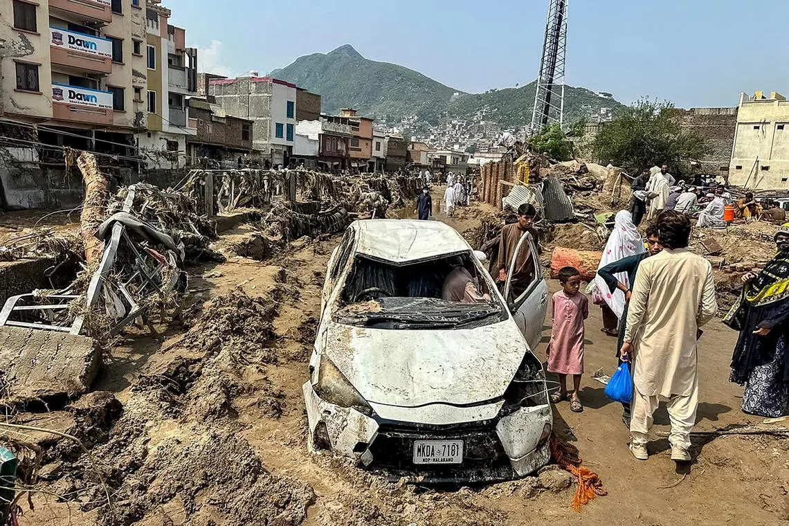 A damaged vehicle after a flash flood in Mingora, Pakistan, on Aug 16.