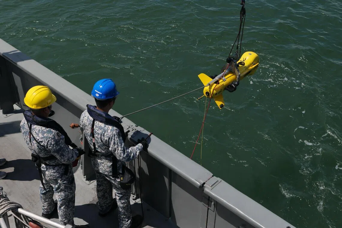 Crew members of the RSS Punggol, a mine countermeasure vessel, launching a K-STER on June 23. The K-STER is a remotely operated underwater mine disposal vehicle that can neutralise sea mines without putting personnel in danger.
