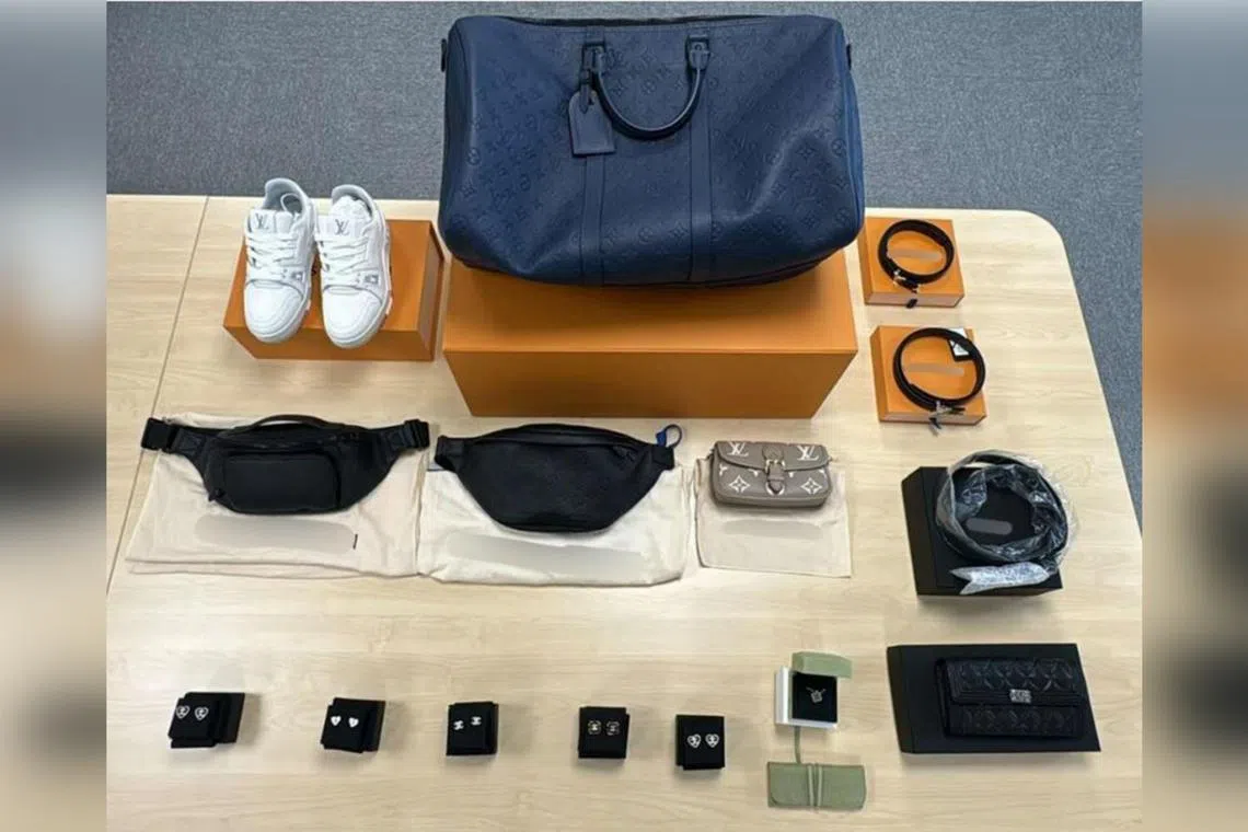 They were at a Louis Vuitton store at MBS on April 2 when they allegedly used details linked to a Mastercard to buy a pair of shoes and a belt worth $2,575 in total.