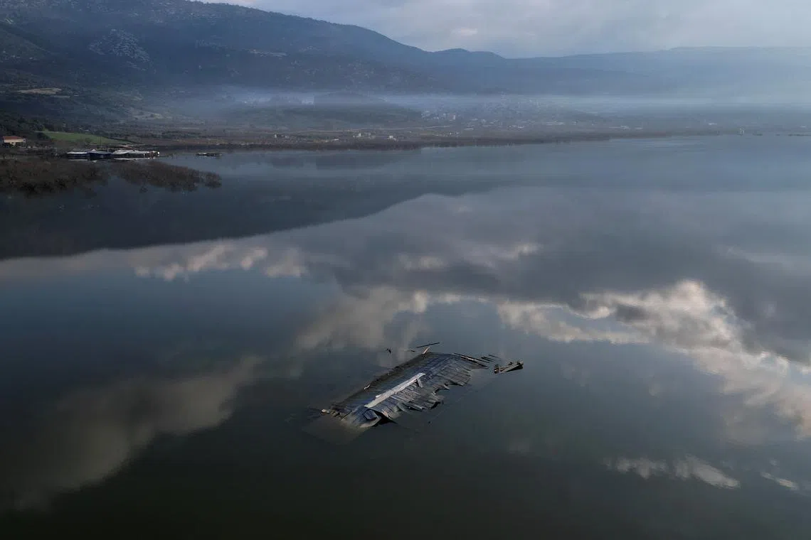 FILE PHOTO: A livestock farm is almost entirely submerged by floodwater, following the extreme flooding of last September, in the village of Kanalia, Greece, February 17, 2024. REUTERS/Alkis Konstantinidis/File Photo