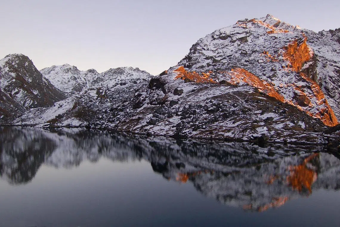 Gosainkund Lake is one of the holy lakes in the Langtang region in Nepal. This photo captures the reflection of the mountain in the lake at sunset. Temperatures were freezing at this elevation of 4,380m during autumn in November.