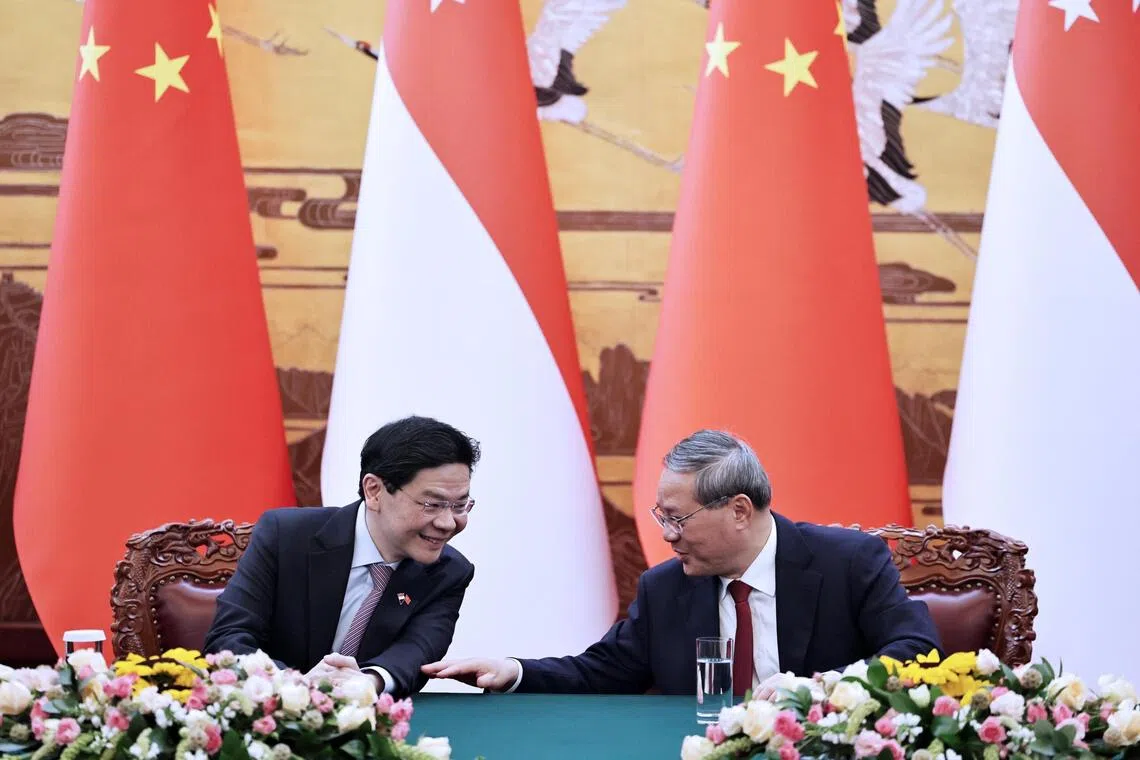 Singapore Prime Minister Lawrence Wong (left) and Chinese Premier Li Qiang meeting in Beijing on June 23.