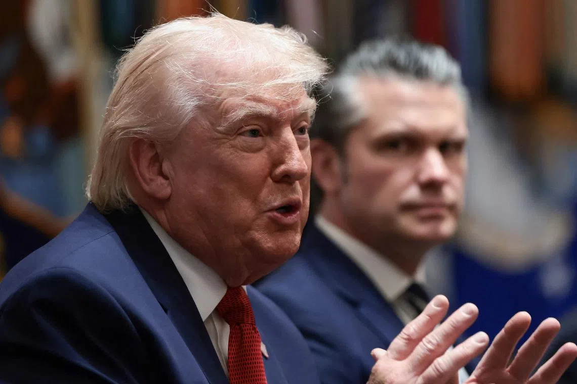 U.S. President Donald Trump speaks next to Defense Secretary Pete Hegseth during a cabinet meeting at the White House in Washington, D.C., U.S., March 26, 2026. REUTERS/Evelyn Hockstein