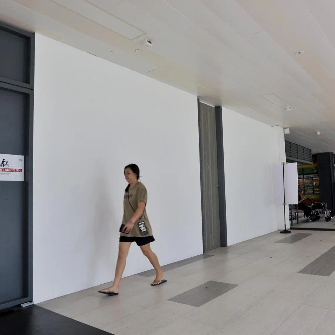 A shopper walking past a vacant shop on the first floor of Northshore Plaza II on April 14, 2026.