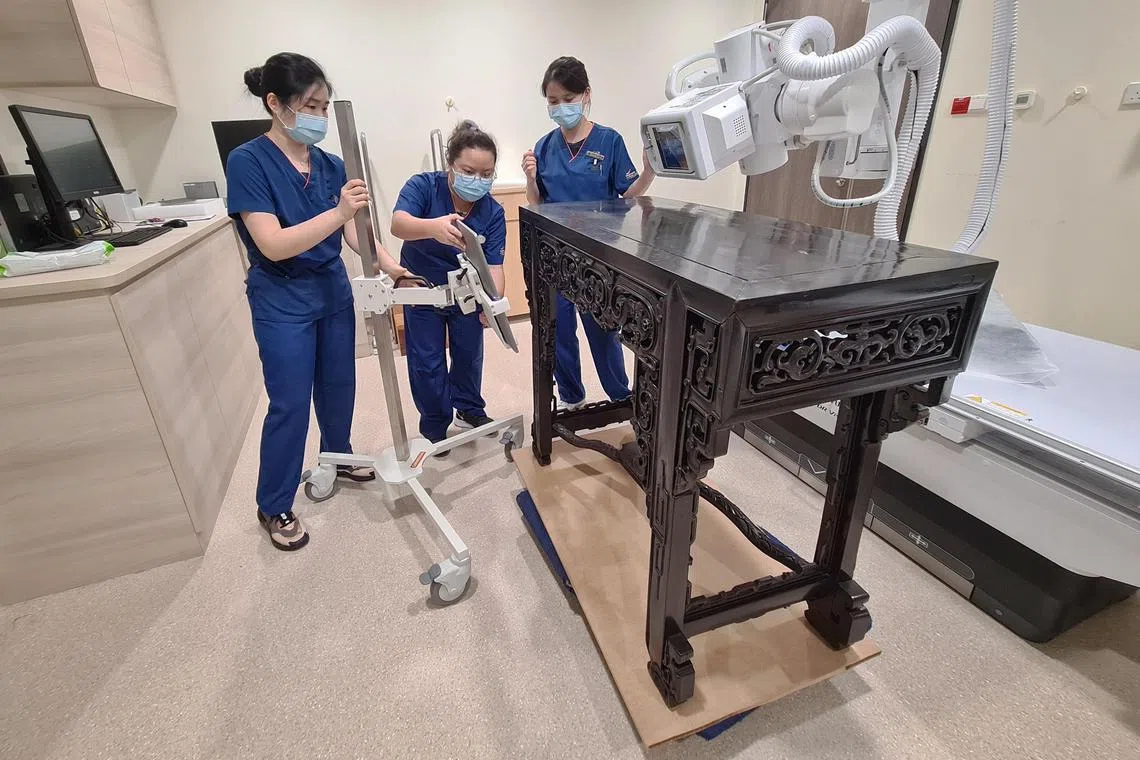Sidetables from the ancestral home of Tan Kim Seng, Panglima Prang, are scanned using X-ray as part of research and conservation efforts at Singapore General Hospital in Singapore on 26 November 2022.