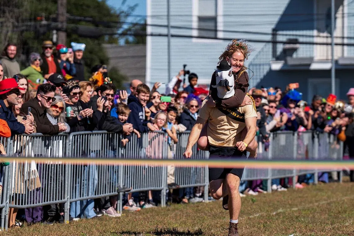 People participating in the sixth annual Thanksgiving day Human Horse Race in New Orleans, Louisiana, US, Nov 27, 2025. 