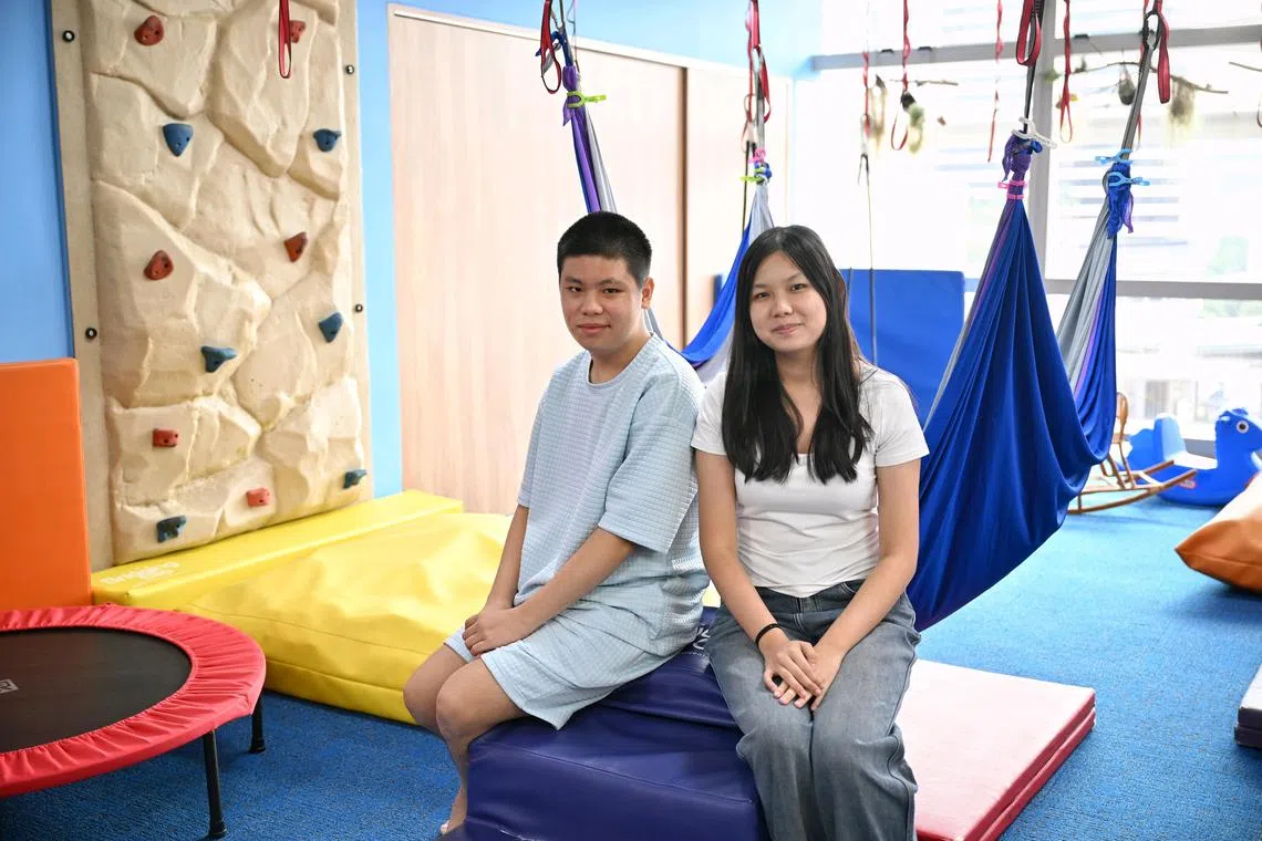 Emmanuel Lee, 15, with his sister, Isabelle Lee Le Xian, 19, at Bridging the Gap at City Square Mall, a business serving children with special needs started by their mother, Ms Janice Tay.  Ms Lee used to be a "glass child", feeling overlooked as the sibling of a child with special needs.