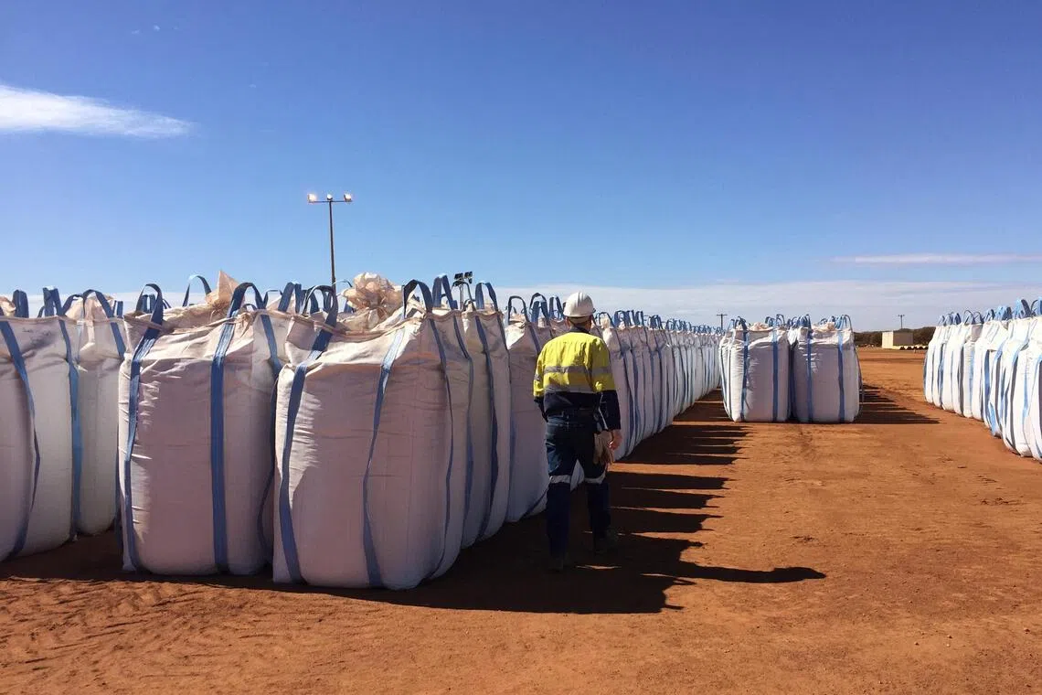 A Lynas Corp worker walks past sacks of rare earth concentrate waiting to be shipped to Malaysia.