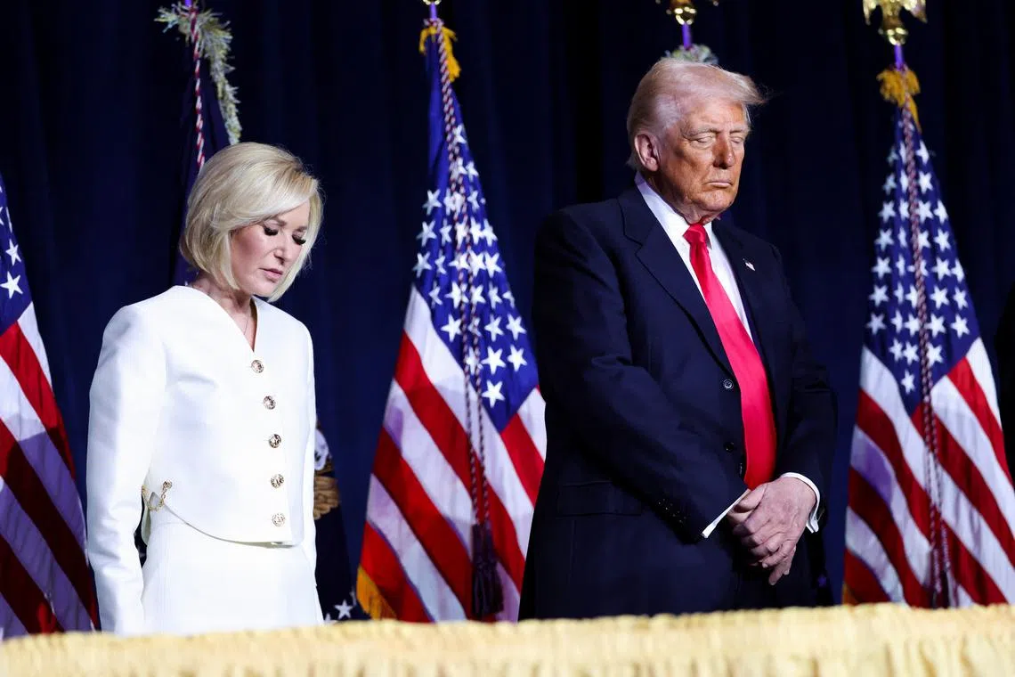 US President Donald Trump and his spiritual adviser Paula White at the annual national prayer breakfast in Washington on Feb 6.