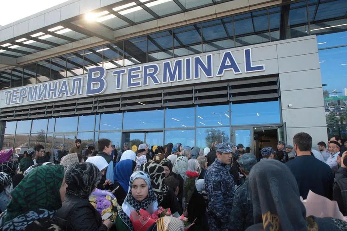 FILE PHOTO: People wait for arriving passengers outside the airport terminal in Makhachkala in the region of Dagestan, Russia October 31, 2023. REUTERS/Kazbek Basayev/File photo