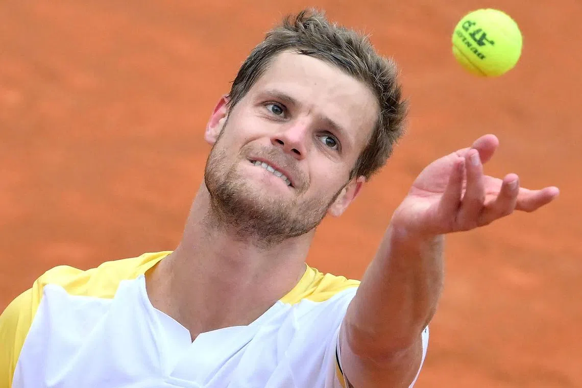 Germany's Yannick Hanfmann wears a hearing aid off the courts, but plays without it.