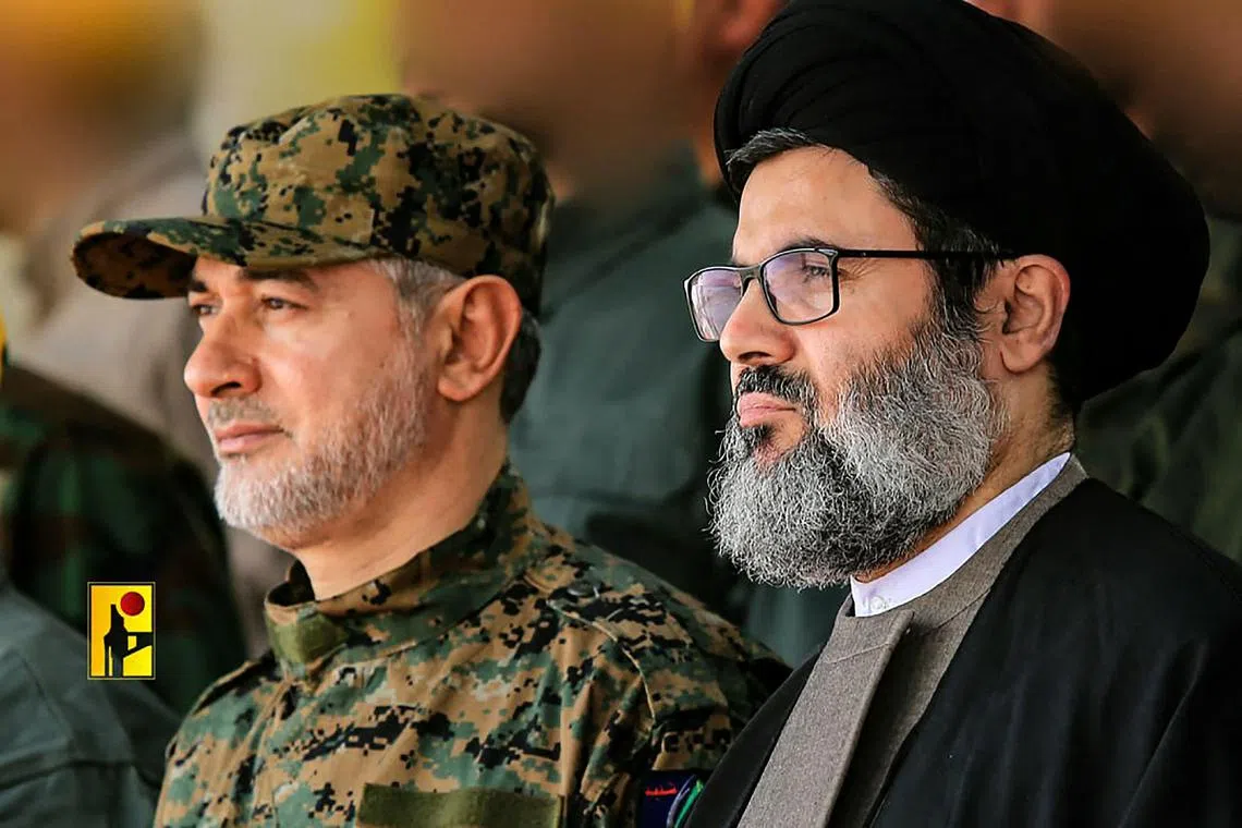 An undated handout photo released by the Hezbollah military media press office on Sept 21, 2024, shows slain Hezbollah top commander Ibrahim Aqil (left) and Senior Hezbollah official Hashem Safieddine at an unknown location. 