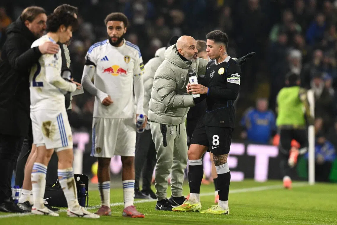 Chelsea manager Enzo Maresca gives instructions to midfielder Enzo Fernandez during a break in play in the Premier League match against Leeds United.