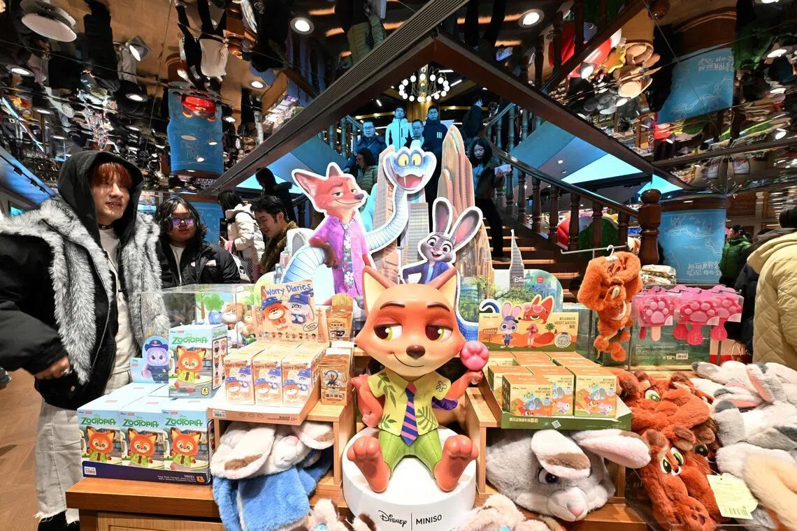 People visit a Miniso shop in Beijing with Zootopia merchandises on display on Dec 20.
