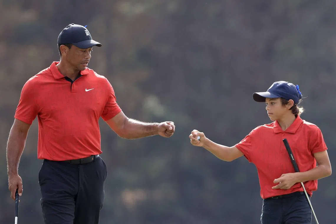 Tiger Woods (left) and his son Charlie during the final round of the 2021 PNC Championship, where they finished second.