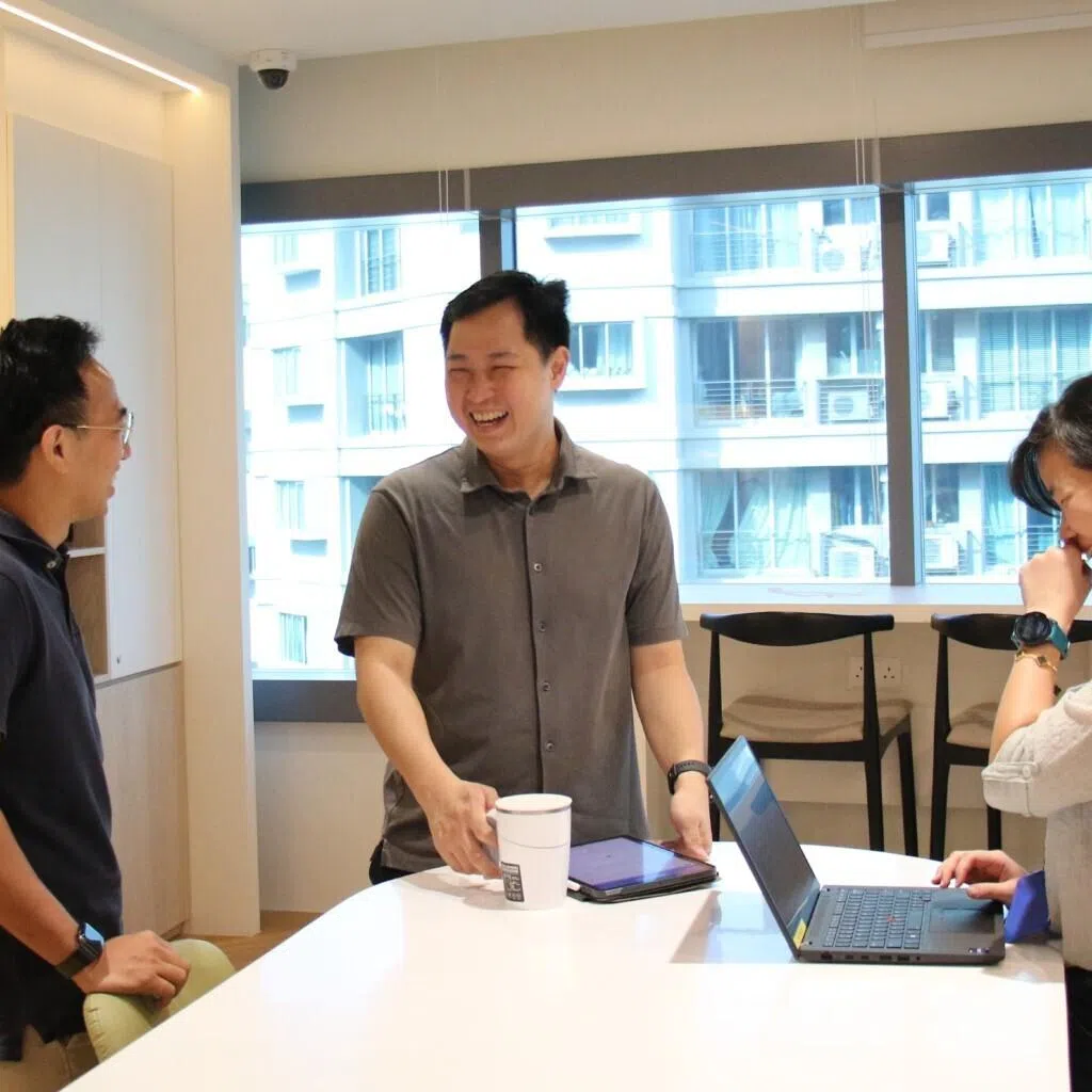 Mr Rafael Tan (middle) spends time with his colleagues in the office pantry to get feedback on how they use office spaces.