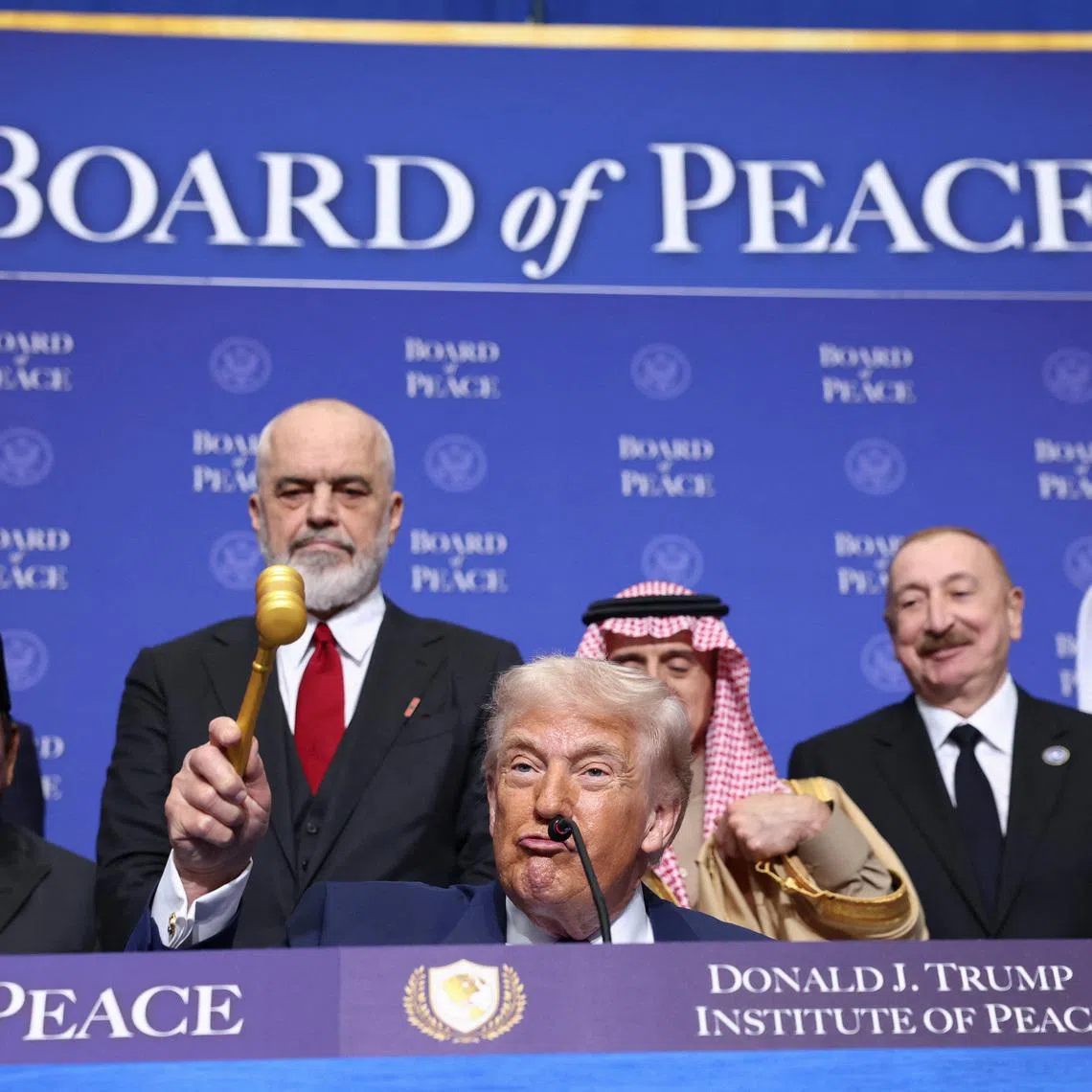 U.S President Donald Trump holds a gavel, during the inaugural Board of Peace meeting at the U.S. Institute of Peace in Washington, D.C., U.S., February 19, 2026. REUTERS/Kevin Lamarque