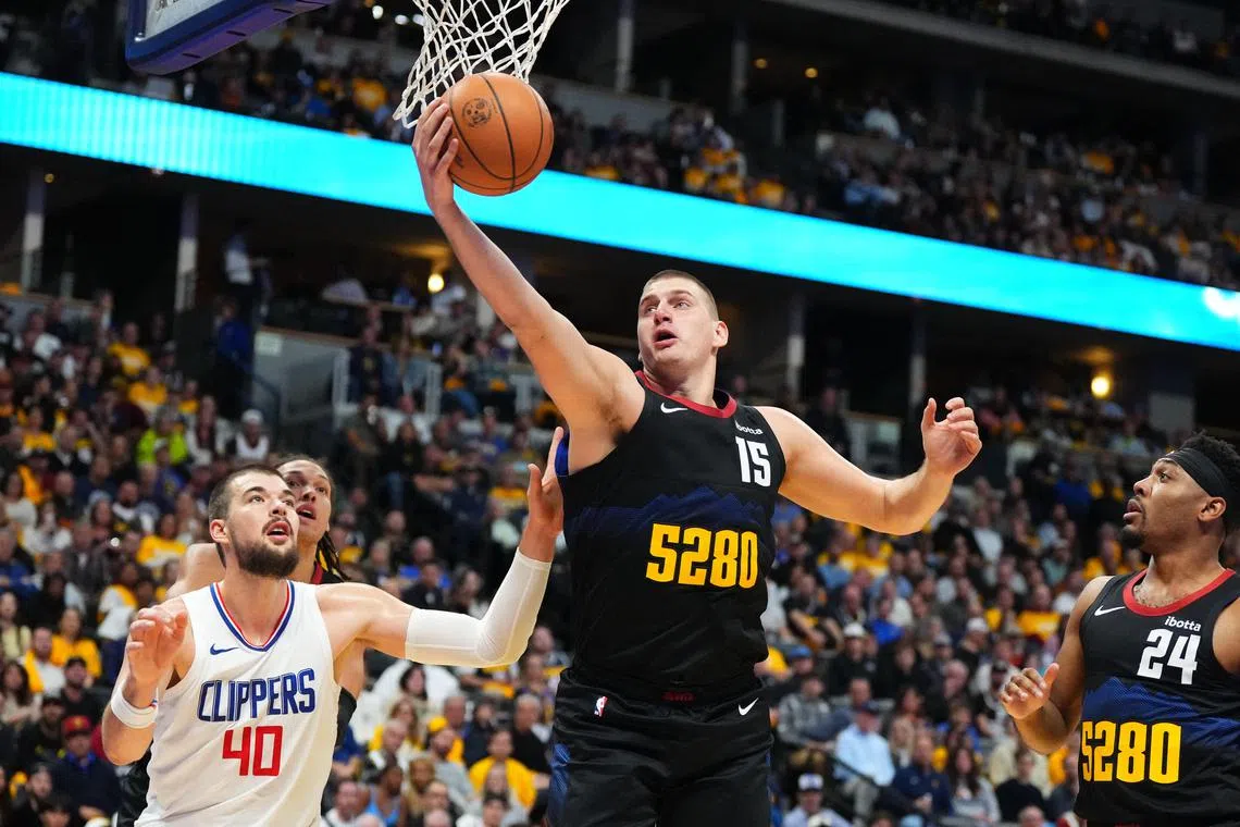 Denver Nuggets centre Nikola Jokic rebounds the ball past LA Clippers centre Ivica Zubac in the second quarter at Ball Arena.