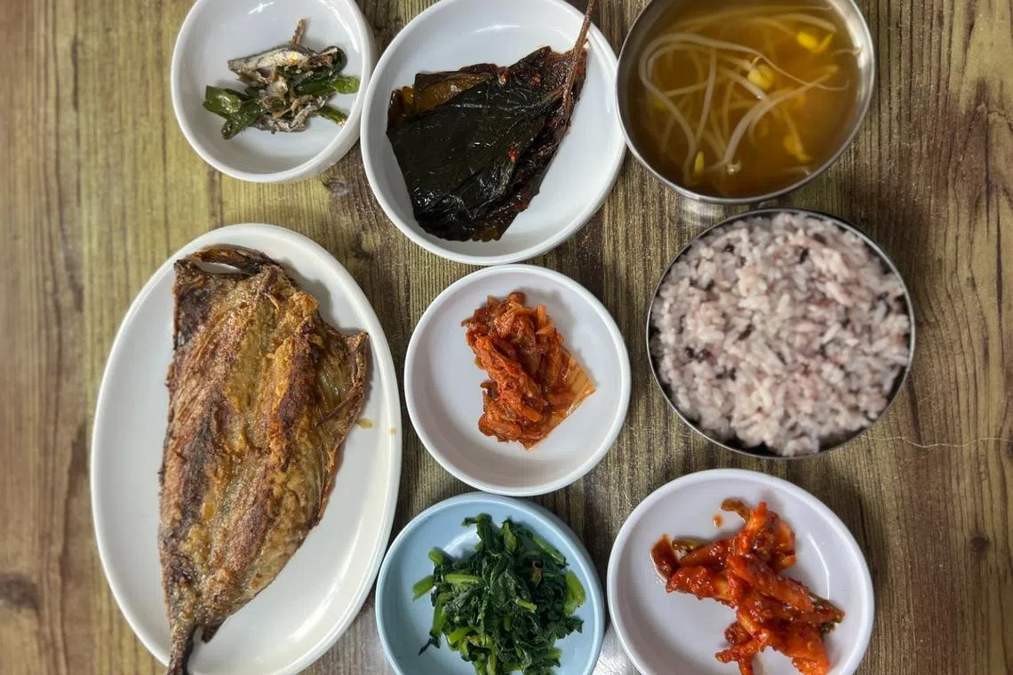 Grilled mackerel is served with a bowl of rice and side dishes at Cheongju Restaurant in Hapjeong-dong, western Seoul.