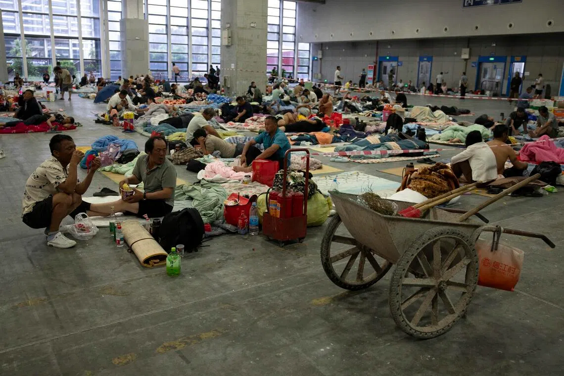 People rest at a shelter set up ahead of Typhoon Bavi’s landfall, in Wenzhou, Zhejiang province, eastern China.
