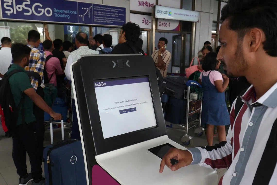 A passenger reads a message after he tried to use a self-check-in kiosk at a departure area at Sardar Vallabhbhai Patel International Airport following a global IT outage, in Ahmedabad, India, July 19, 2024. REUTERS/Amit Dave