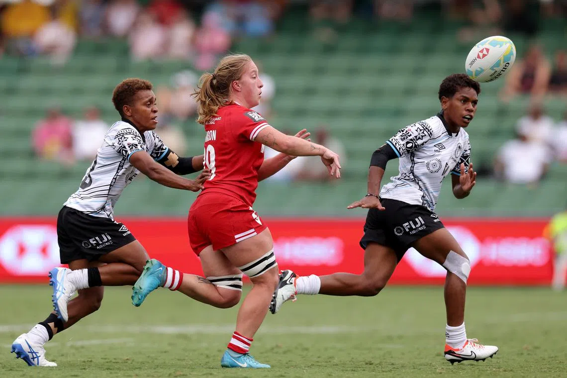 Mahalia Robinson of Canada passes the balls against Fiji during the Rugby SVNS Series at HBF Park in Perth, Australia, on Jan 24.
