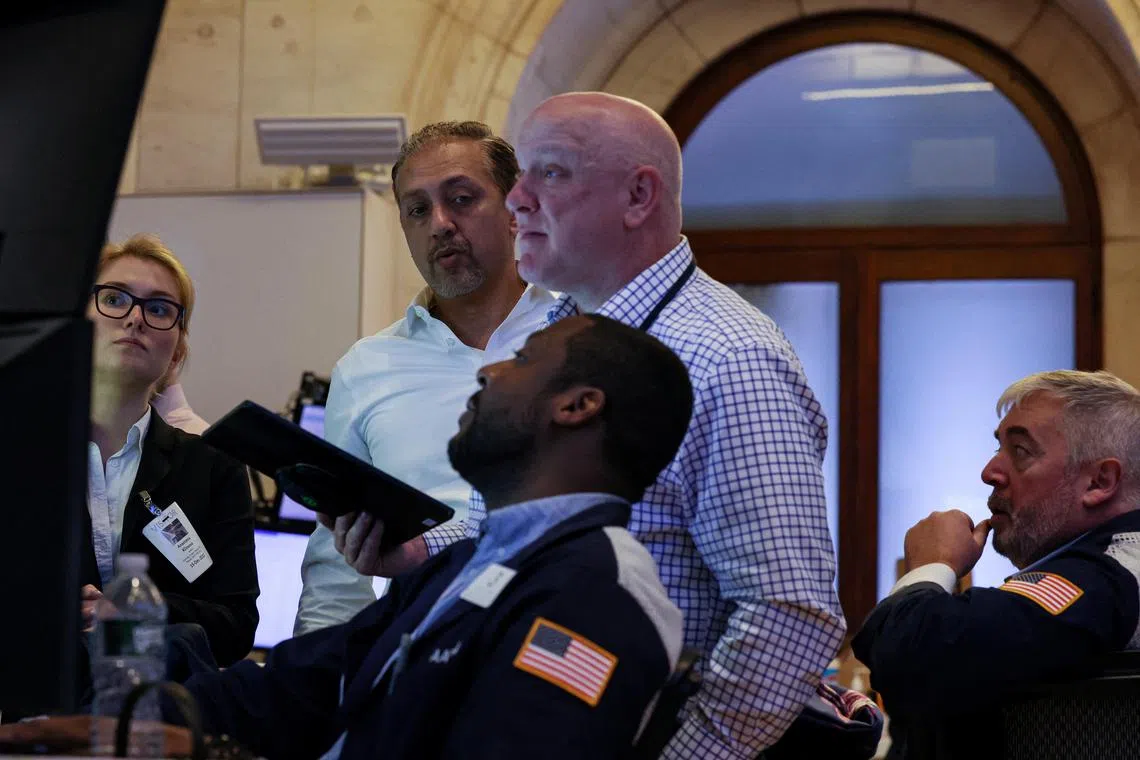 Traders work on the floor at the New York Stock Exchange, in New York City.