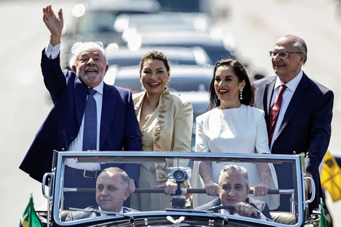 Brazil's President elect Luiz Inacio Lula da Silva waves to supporters on the day of his swearing-in ceremony.