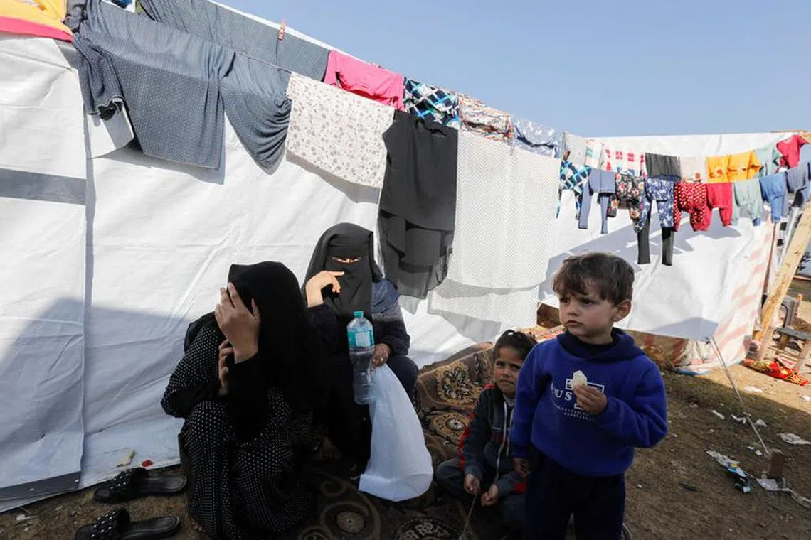 Displaced Palestinians stay outside their tent where they take shelter, as the conflict between Israel and Hamas continues, at Nasser hospital in Khan Younis, in the southern Gaza Strip December 2, 2023. REUTERS/Saleh Salem