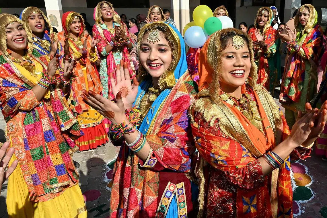 School girls perform Punjabi folk dance 'Giddha' ahead of the upcoming 'Lohri' festival at a government school in Amritsar on January 8, 2025. (Photo by Narinder NANU / AFP)