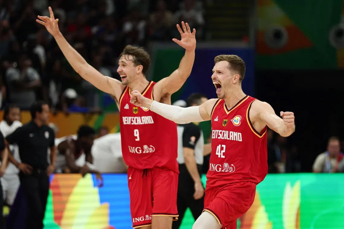 Germany's Andreas Obst and Franz Wagner celebrate after they beat the United States in the Basketball World Cup semi-finals.