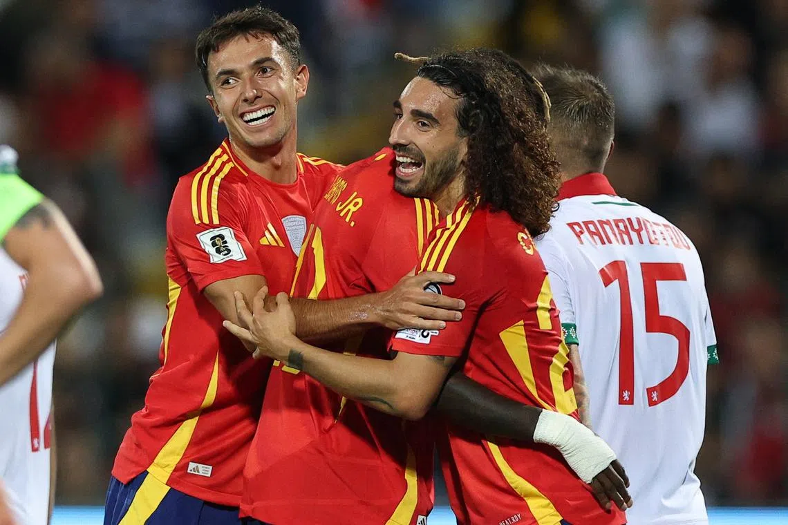 Soccer Football - World Cup - UEFA Qualifiers - Group E - Bulgaria v Spain - Vasil Levski National Stadium, Sofia, Bulgaria - September 4, 2025 Spain's Marc Cucurella celebrates scoring their second goal with Spain's Martin Zubimendi and Spain's Nico Williams REUTERS/Stoyan Nenov