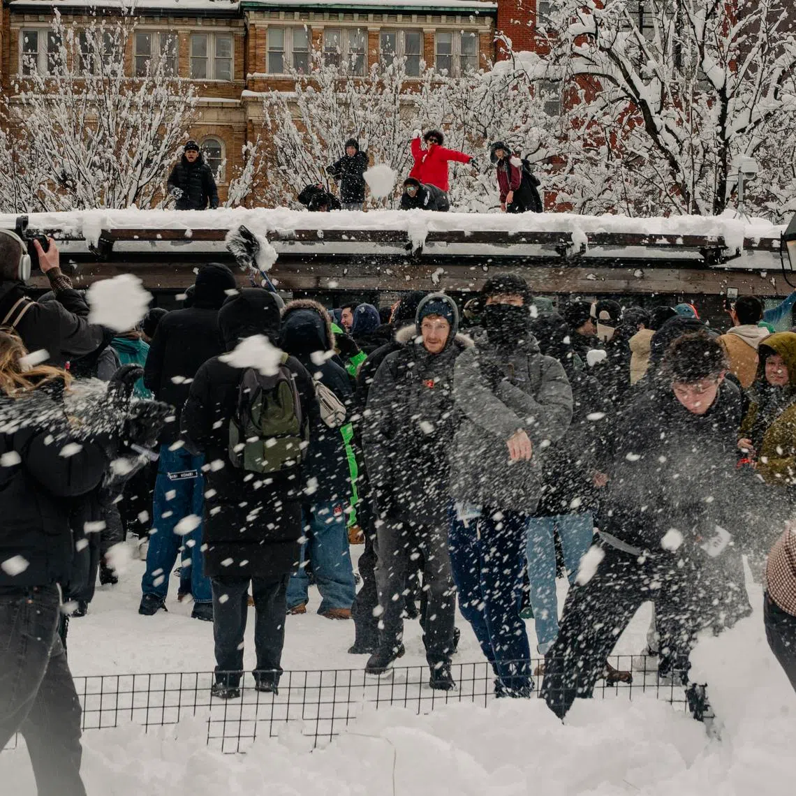 People engage in a snowball fight after a snowstorm at Washington Square Park in New York on Feb 23.
