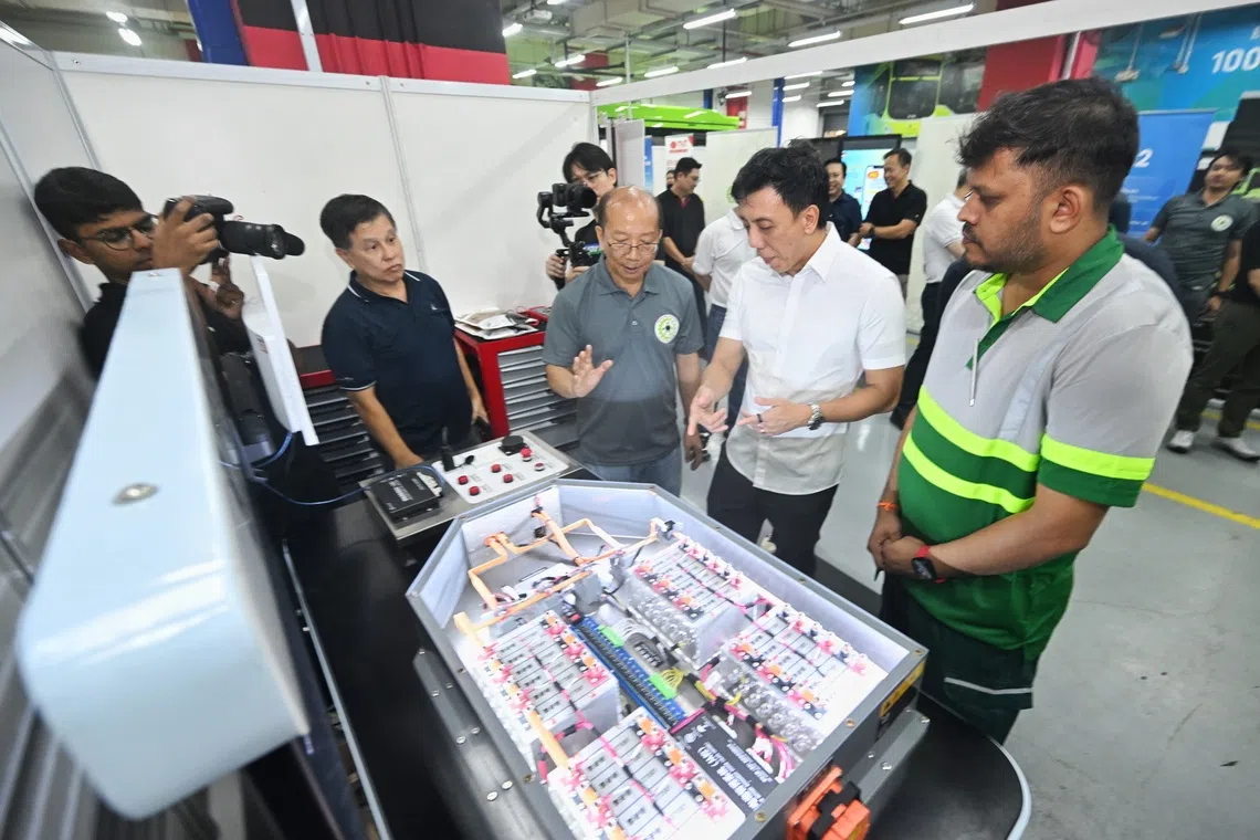 Transport Minister Jeffrey Siow (centre) with technicians at the Singapore BusTech and RailTech Grand Challenge on Oct 24.