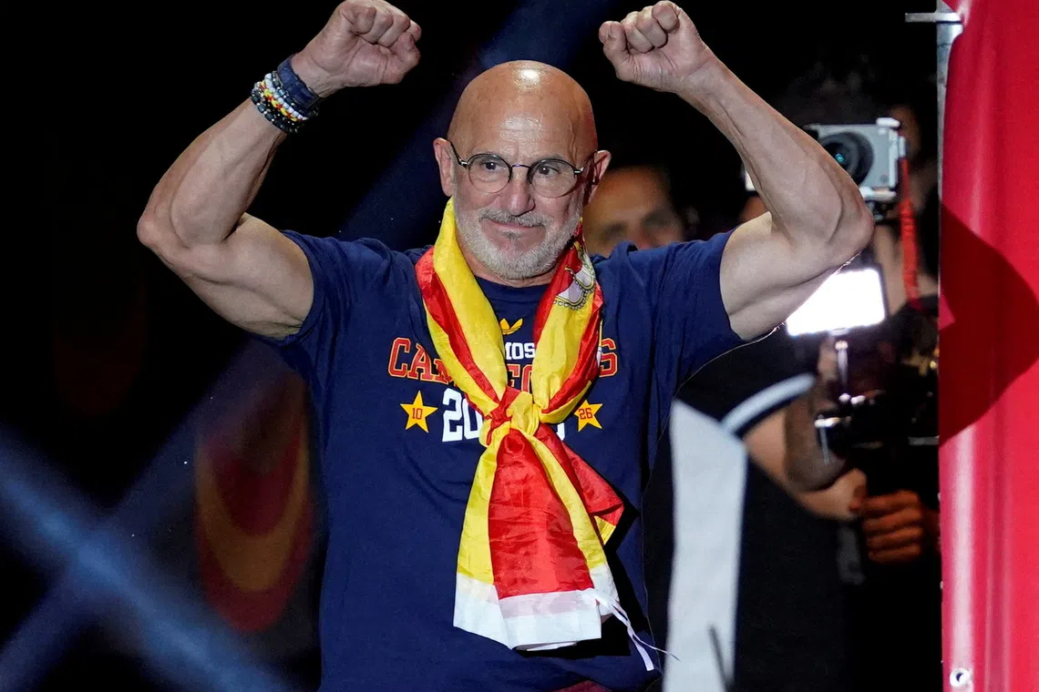 FILE PHOTO: Soccer Football - FIFA World Cup 2026 - Spain Victory Parade - Madrid, Spain - July 20, 2026 Spain coach Luis De La Fuente celebrates on the stage at Cibeles Square in Madrid after the victory parade as fans gather to celebrate winning the World Cup REUTERS/Ana Beltran/File Photo