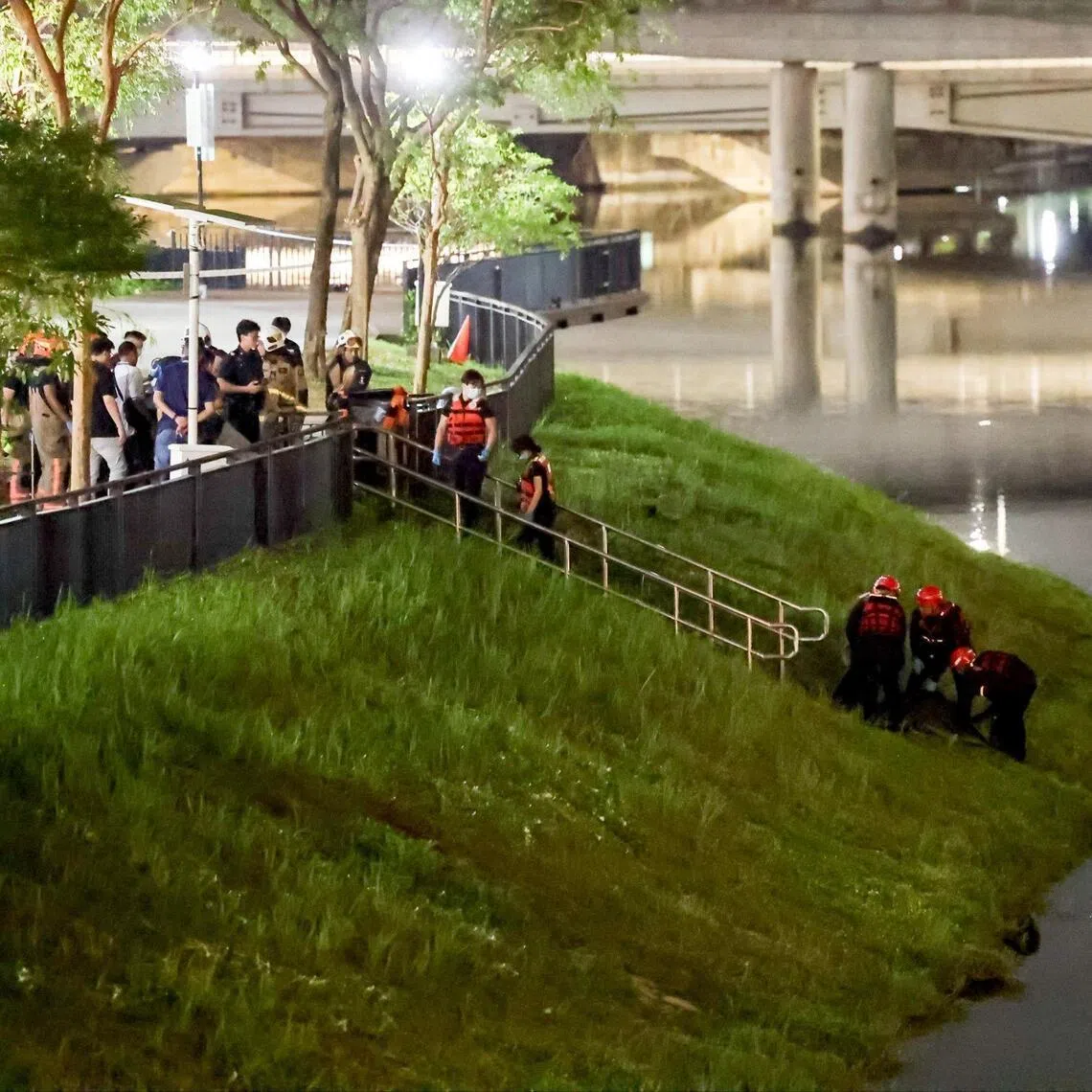 SCDF officers retrieving the boy's body from the Kallang River off Upper Boon Keng Road on Feb 26. 