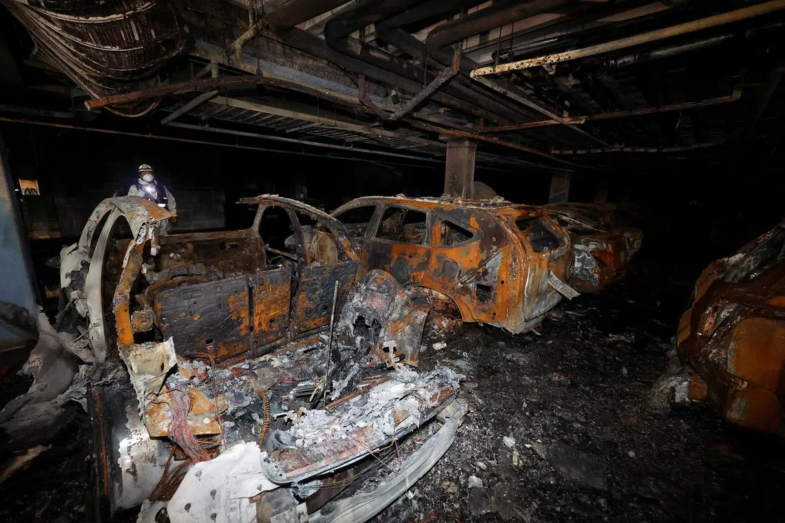 FILE PHOTO: Vehicles that were completely burned down due to a Mercedes Benz electric car fire that broke out on August 1st, are lying in the underground parking lot of an apartment complex in Incheon, South Korea, August 2, 2024. Yonhap/via REUTERS /File Photo