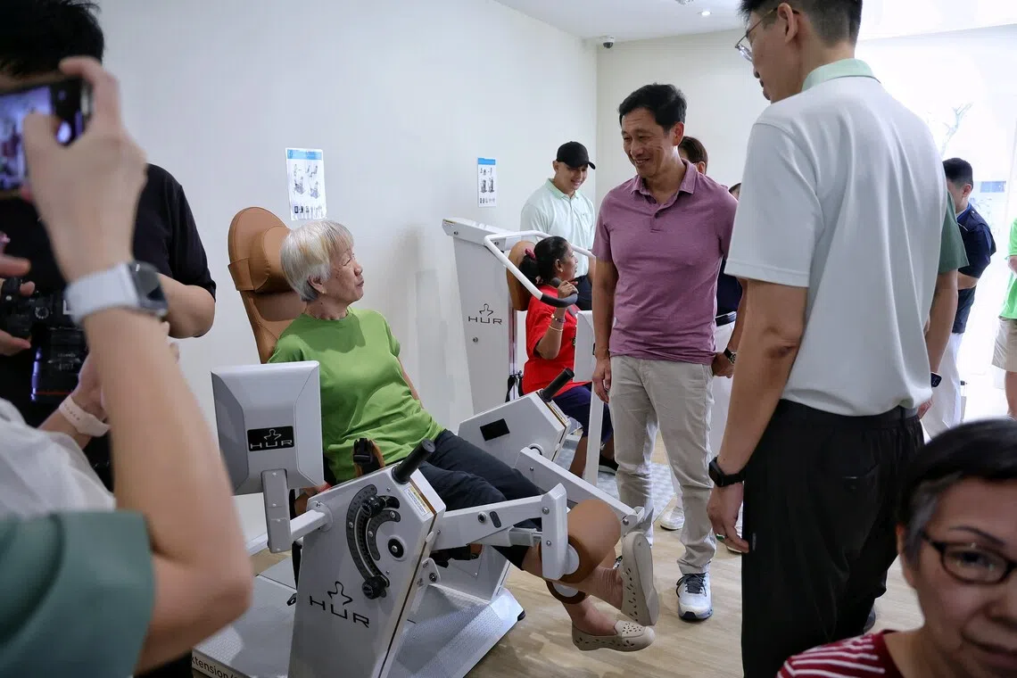 Health Minister Ong Ye Kung (in purple) interacting with seniors working out at the Longevity Courtyard in GLOW (Nanyang) during its opening at 706 Jurong West Street 71 on Nov 15.