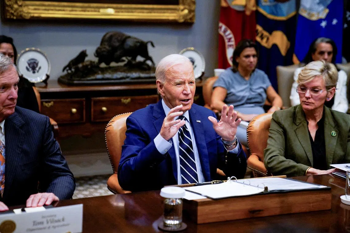 FILE PHOTO: U.S. President Joe Biden speaks about the federal government response to Hurricane Helene and preparations for Hurricane Milton, as he sits between U.S. Secretary of Agriculture Tom Vilsack and U.S. Secretary of Energy Jennifer Granholm, from the Roosevelt Room of the White House in Washington, U.S., October 8, 2024. REUTERS/Elizabeth Frantz/File Photo